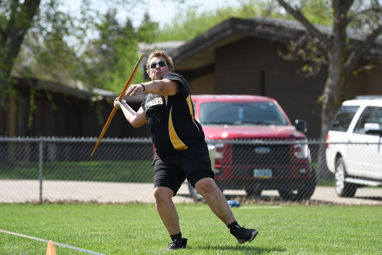 Athlete prepares for discus throw at outdoor track meet.