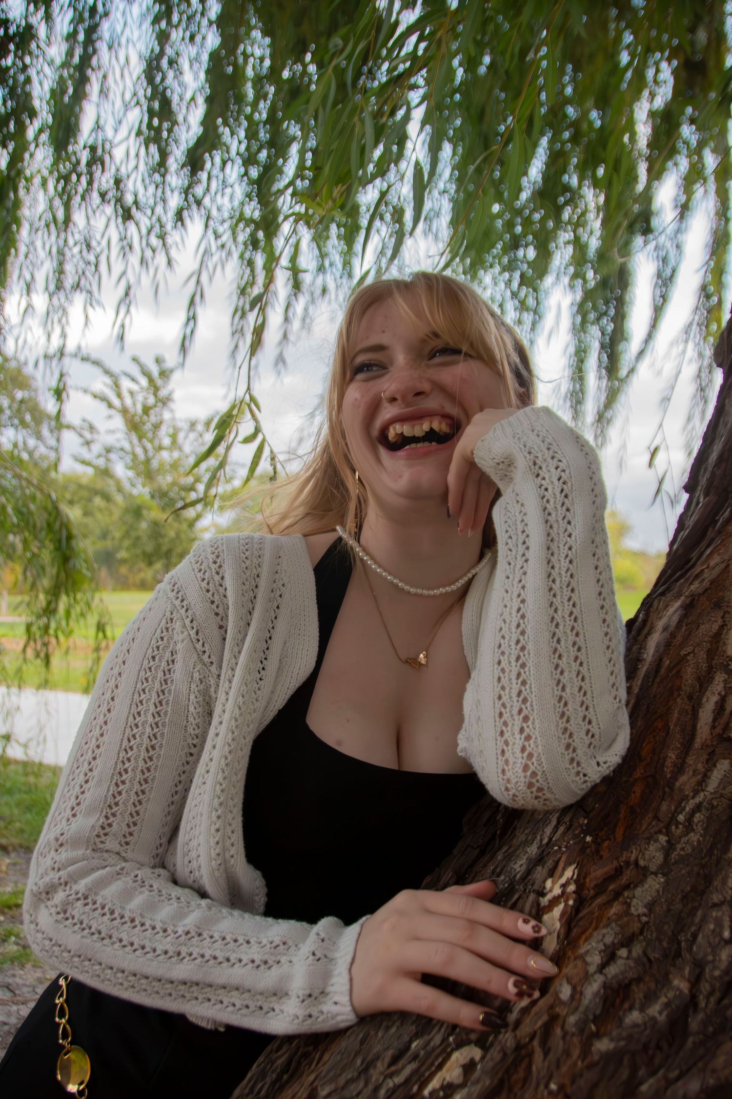 A series of candid moments under a willow tree showing laughter and joy while holding a drink.
