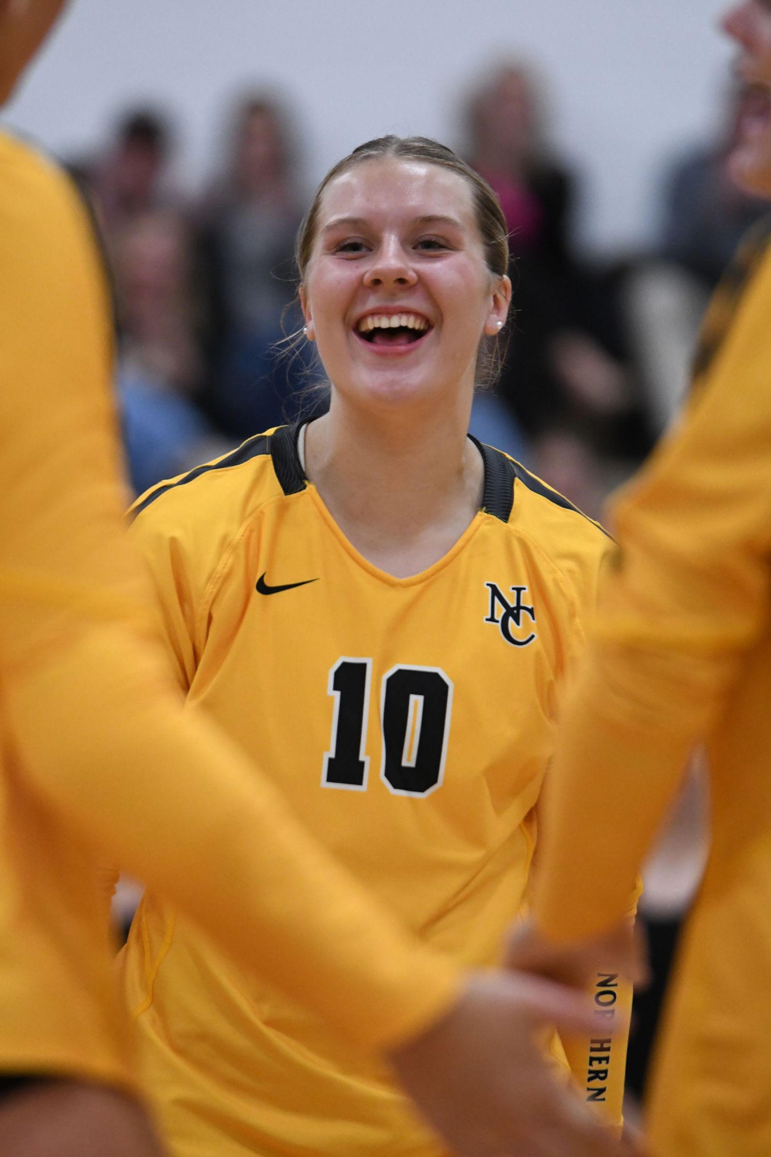 Player in yellow jersey celebrates during volleyball match.