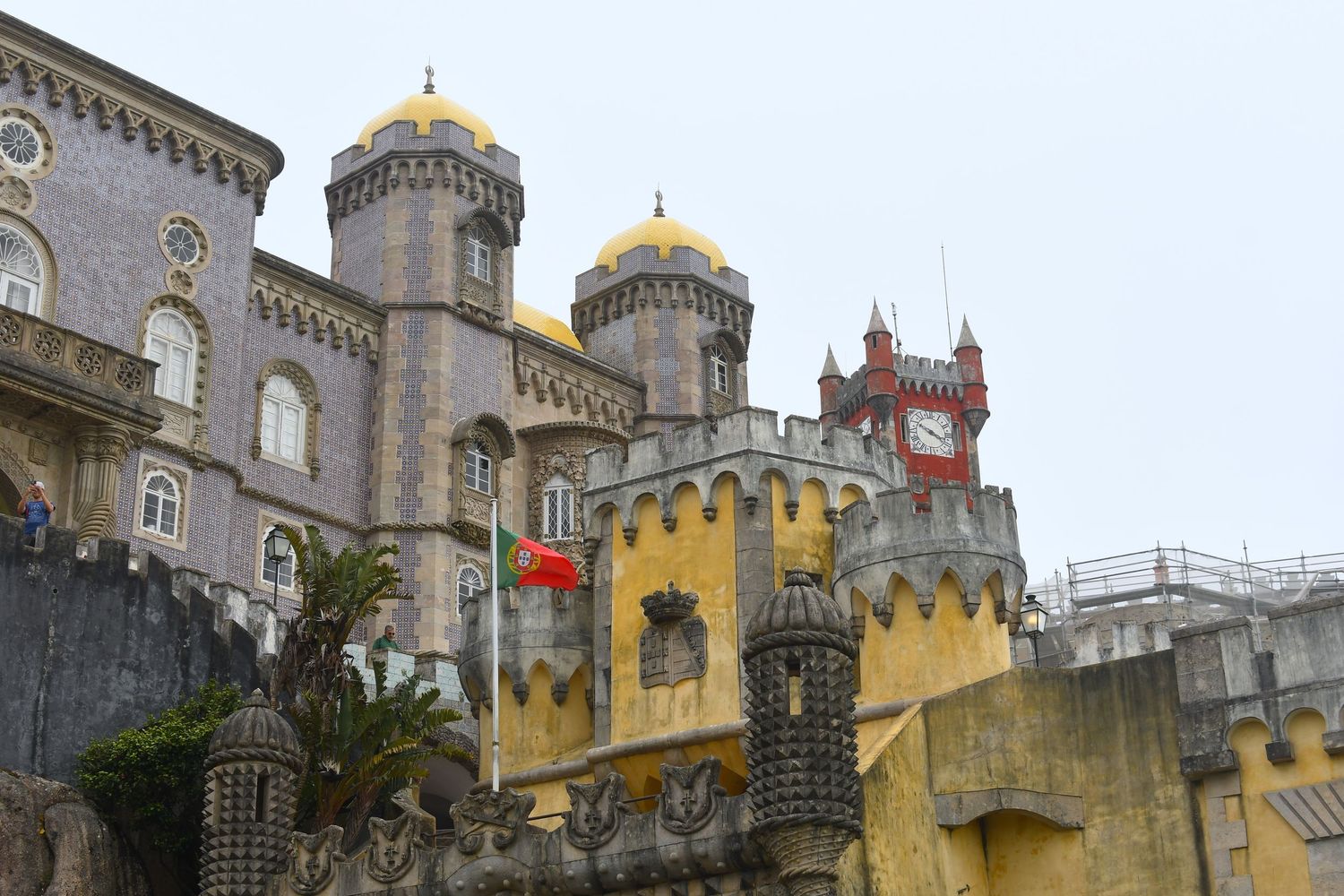 Colorful Pena Palace in Sintra with its distinctive yellow walls and stone towers.