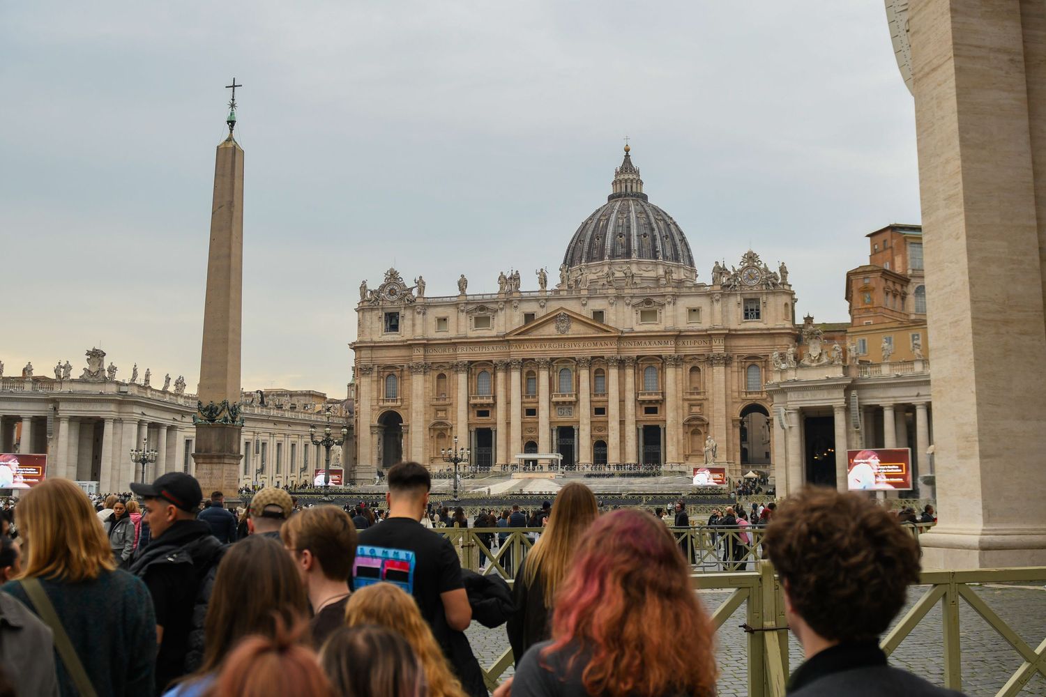 St. Peter's Basilica and Square in Vatican City with its iconic dome and obelisk under cloudy skies.