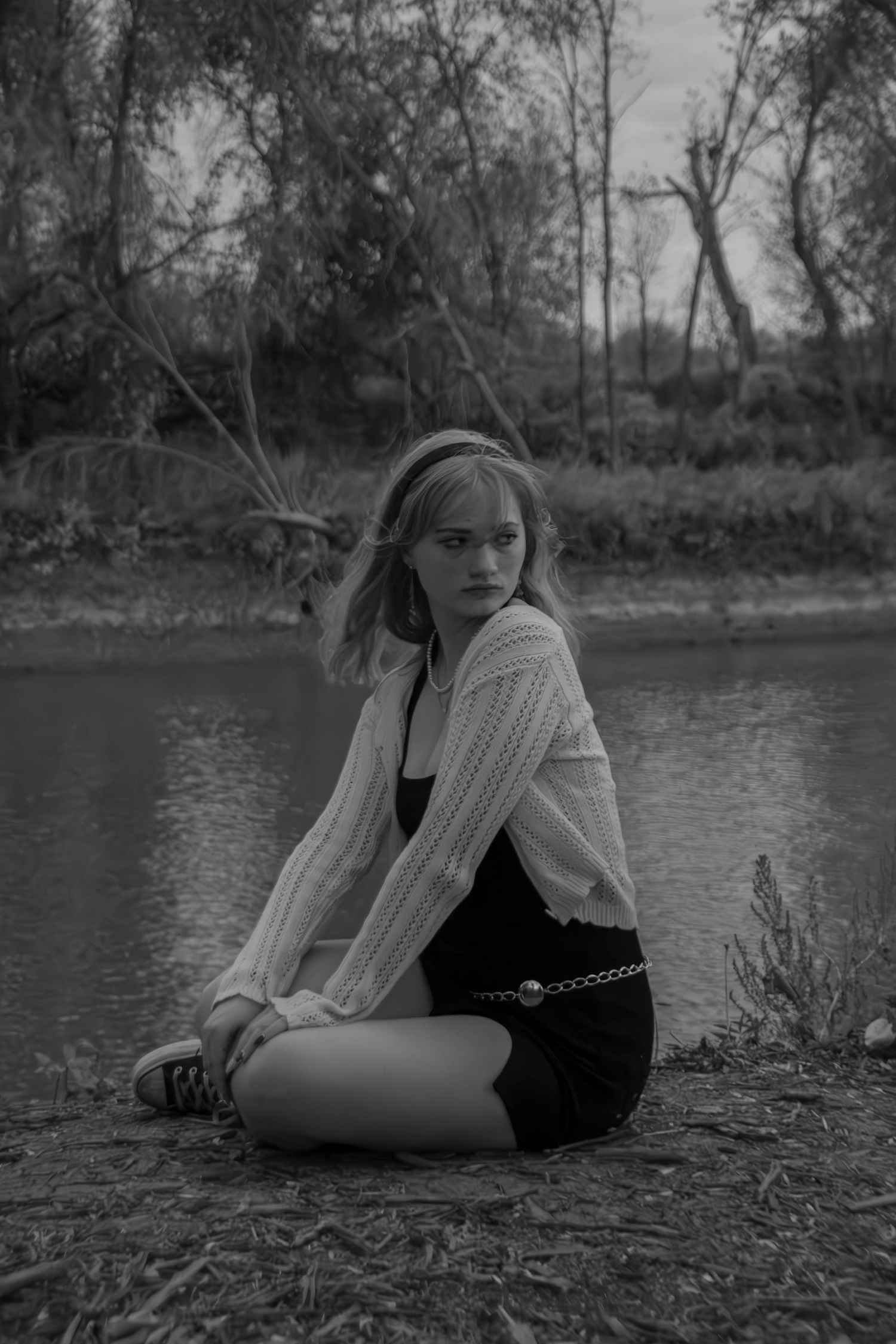 A series of black and white photos showing someone reclining on a riverbank in a contemplative pose.
