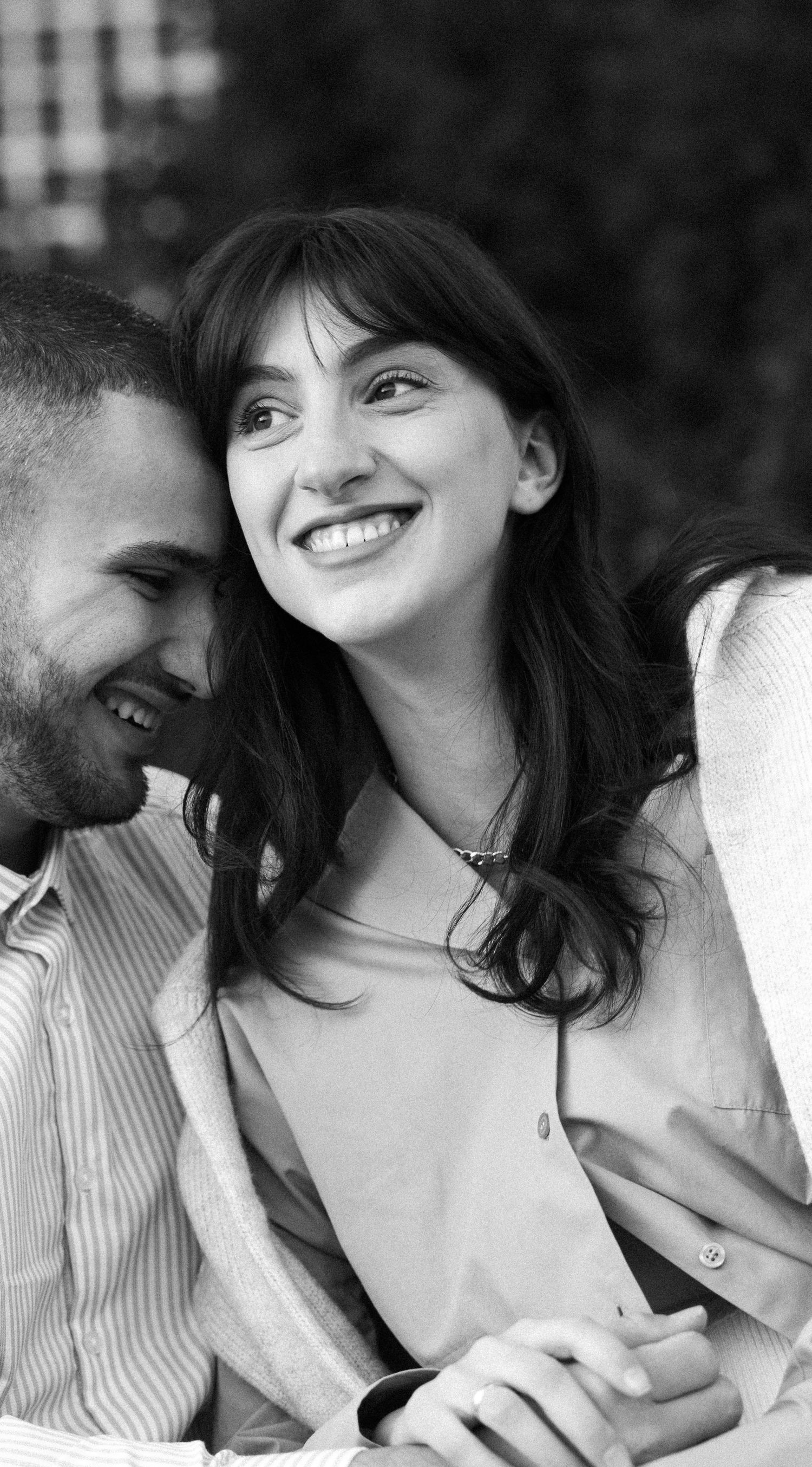 Black and white romantic photo sequence showing a couple in white sweaters sharing intimate moments together.