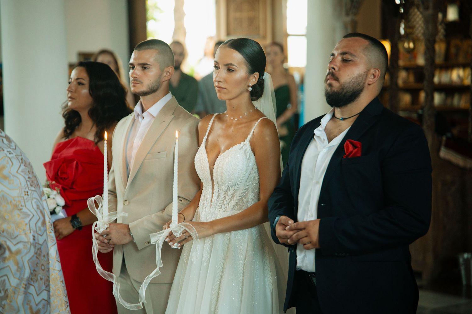 Bride and groom standing at the altar during a church wedding ceremony with guests.