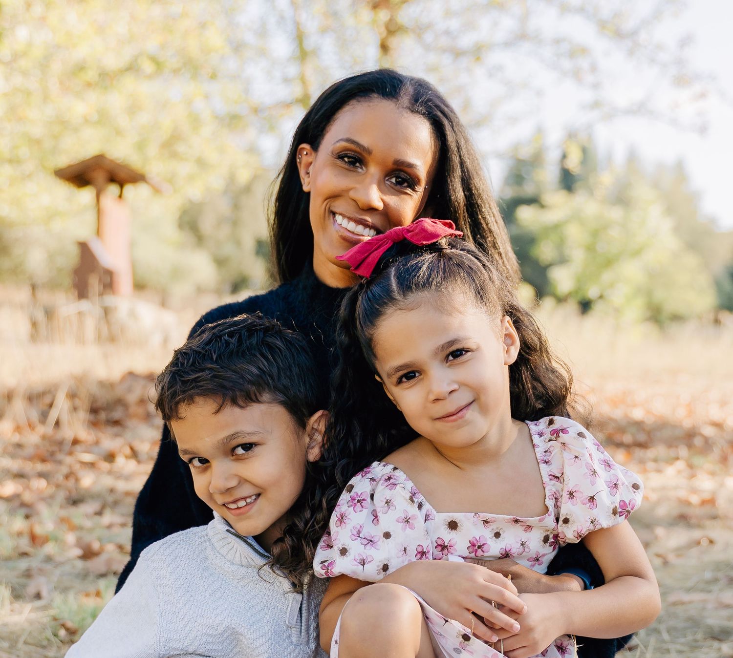 Loving family portrait session showing genuine affection and laughter in golden sunlight.