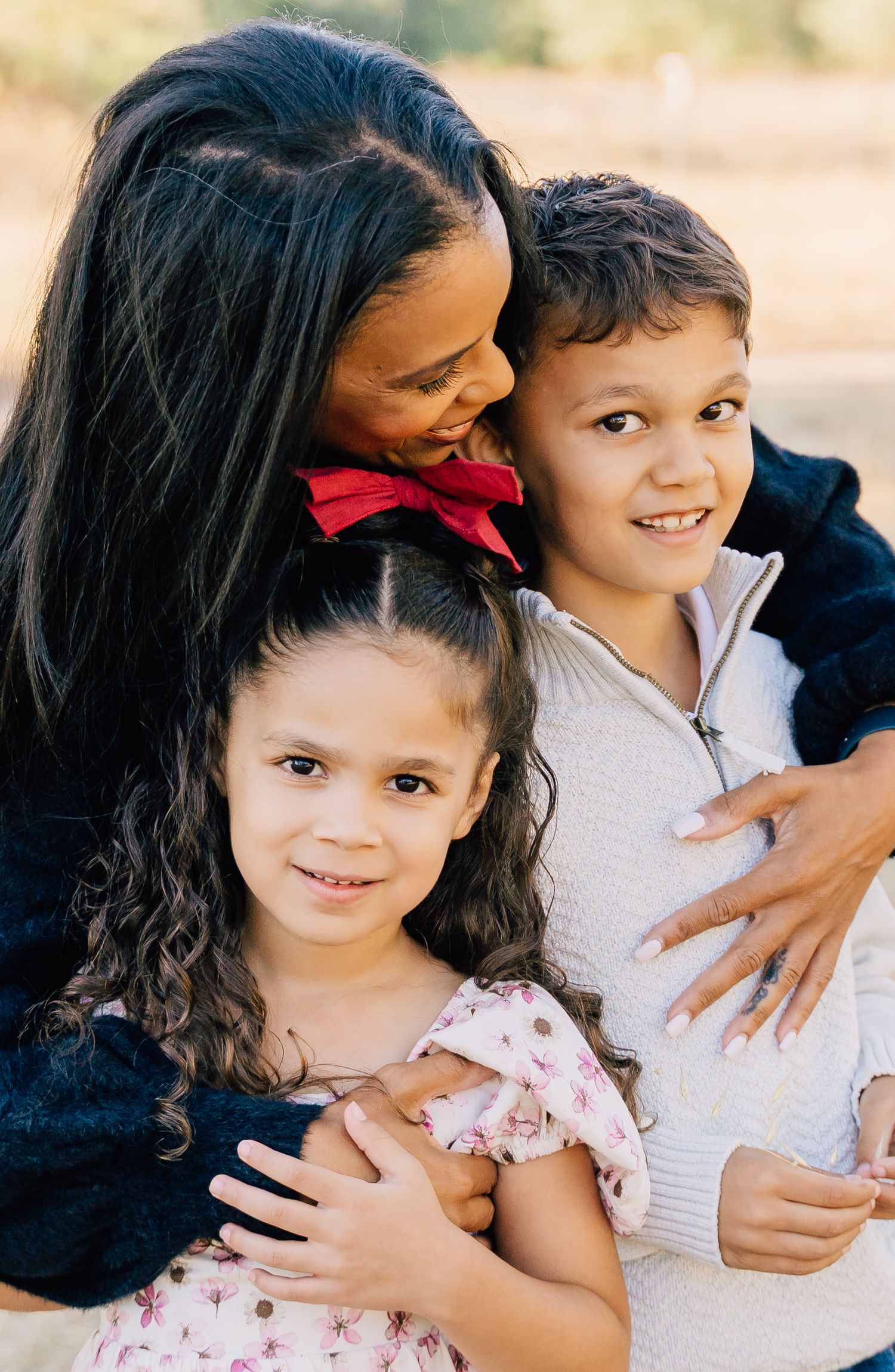 A series of candid family portrait shots showing tender moments between parent and child outdoors.