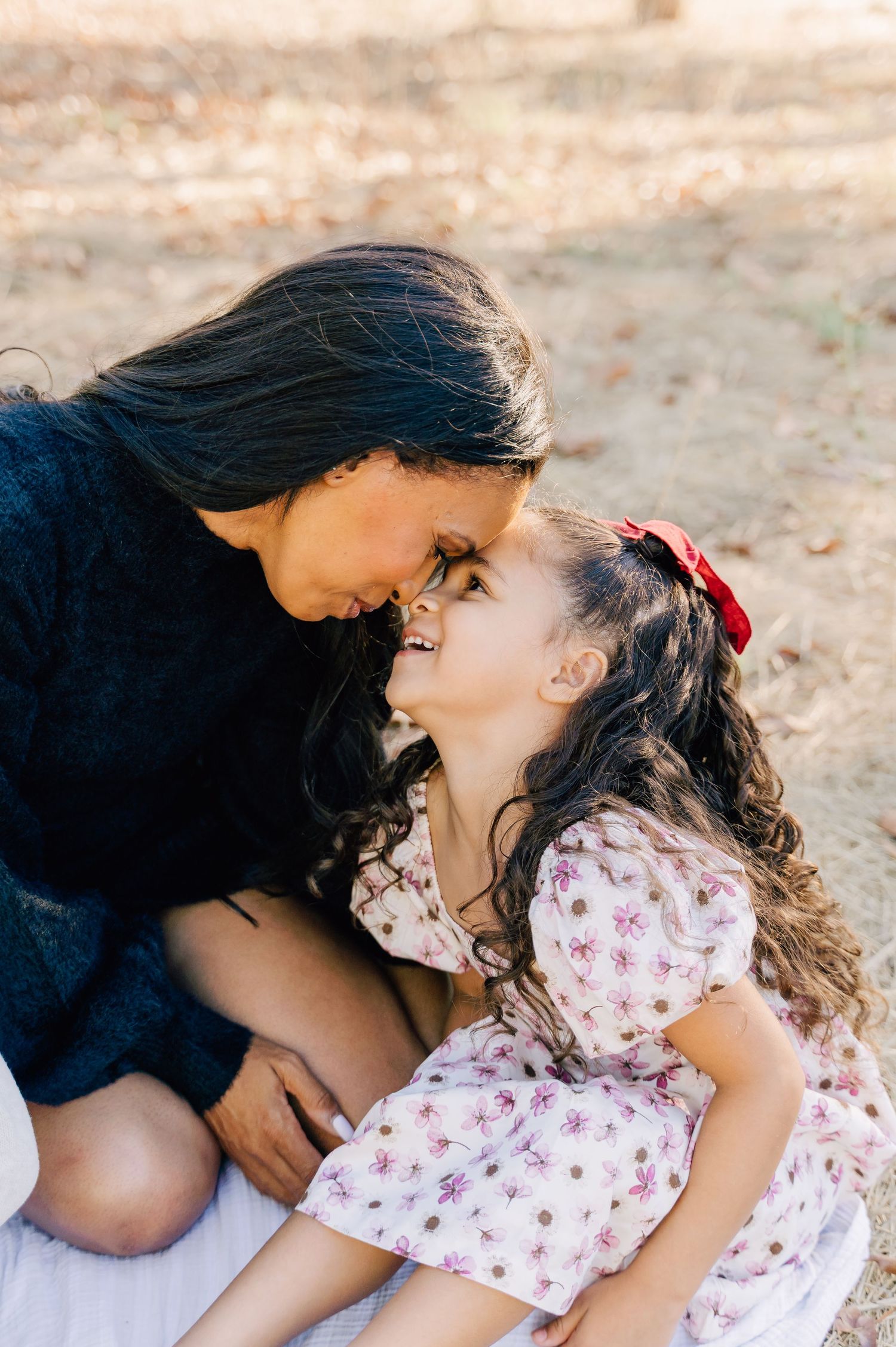 A tender family photoshoot sequence showing intimate moments of connection and laughter on a sunny day.