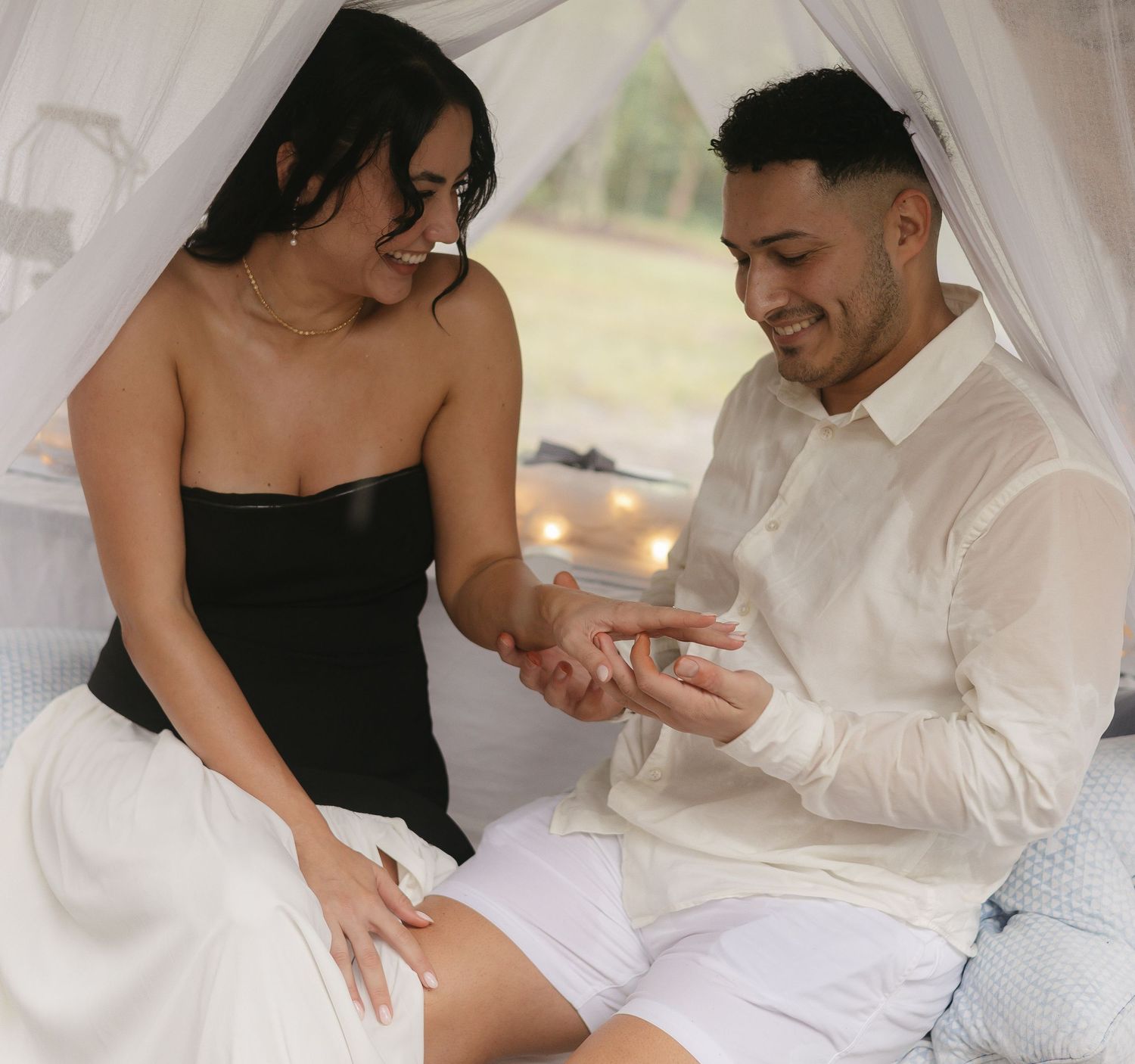 Groom proudly showing wedding ring in heartfelt engagement photo