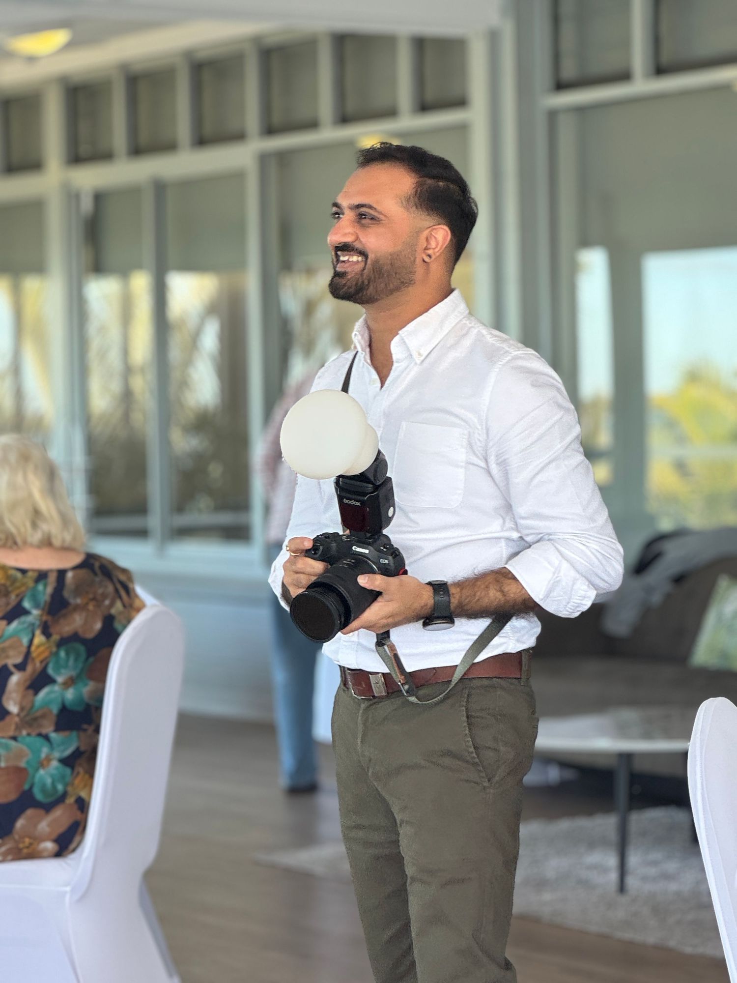 About Me. Behind the scenes of photoshoot with photographer working in bright indoor space.