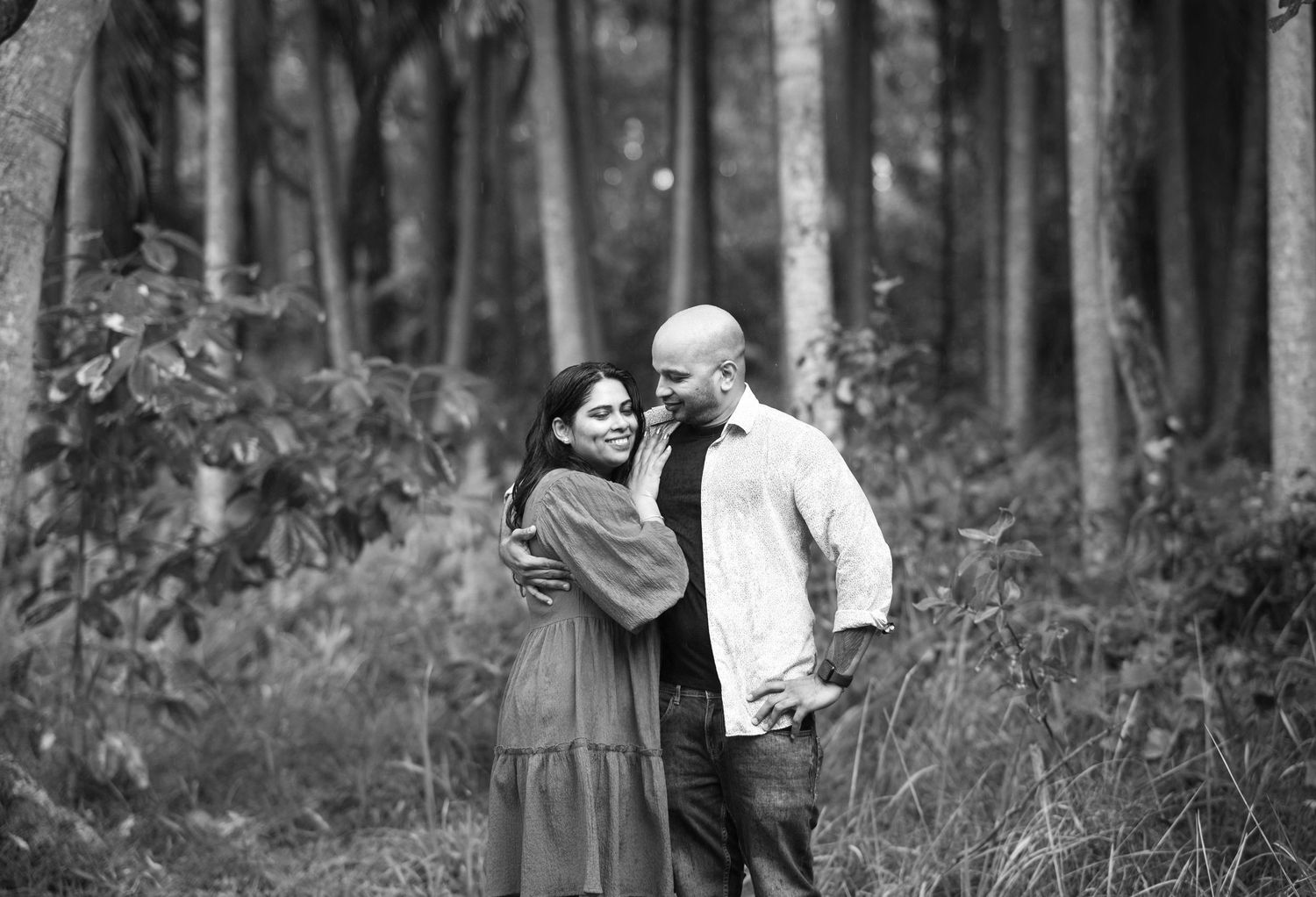 Scenic woodland engagement photoshoot showing silhouettes against natural forest backdrop.