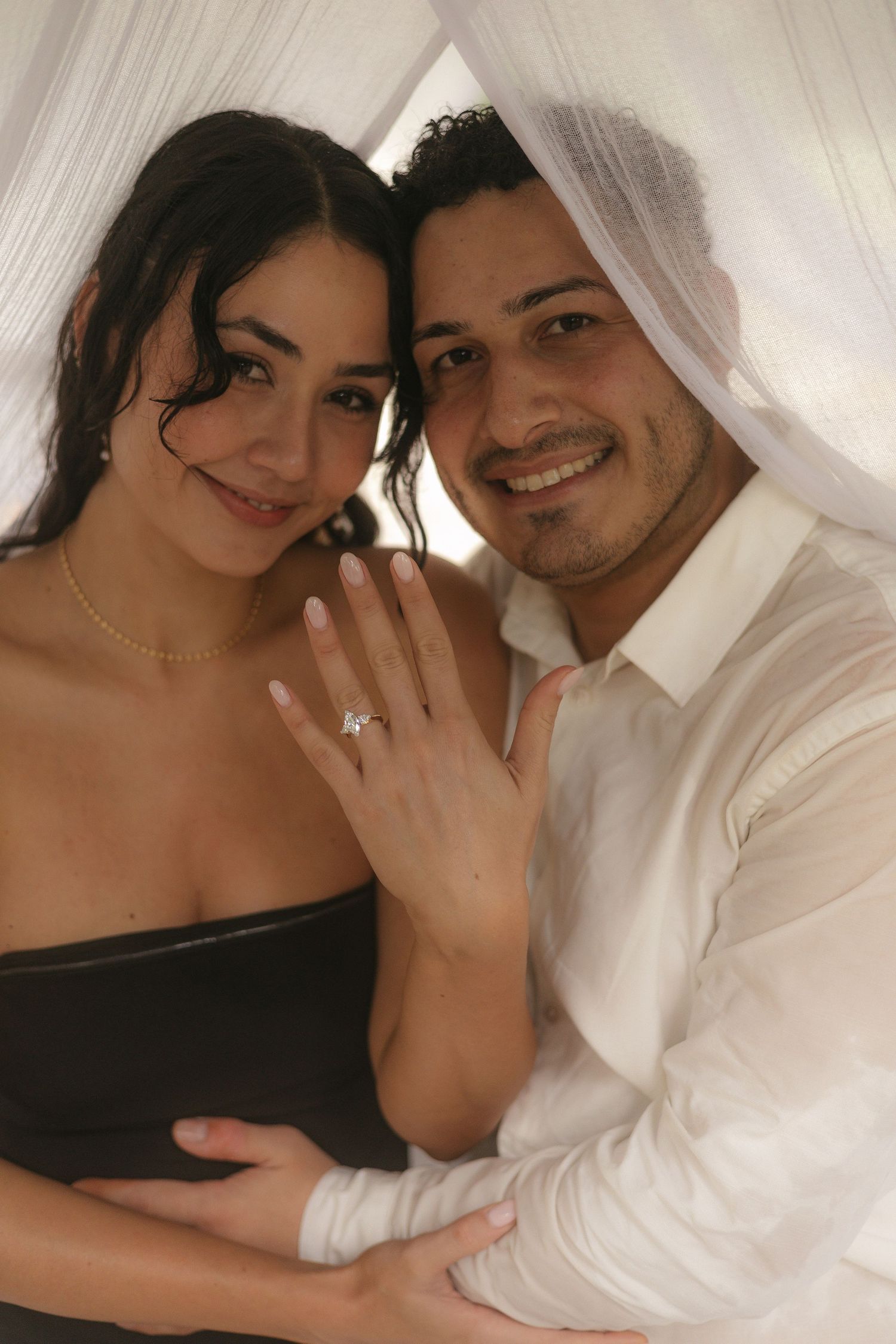 Happy engagement photos showing joyful moments and a new ring in a light-filled setting.