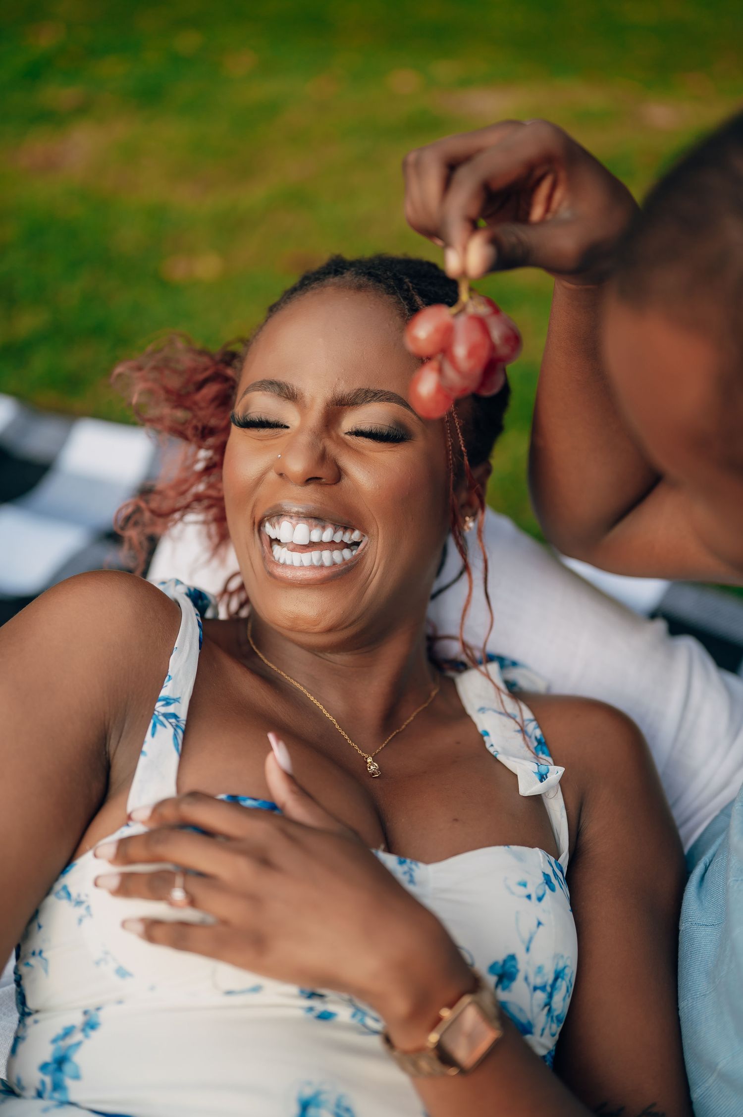 Candid sequence showing genuine laughter and joy in white and blue dress.