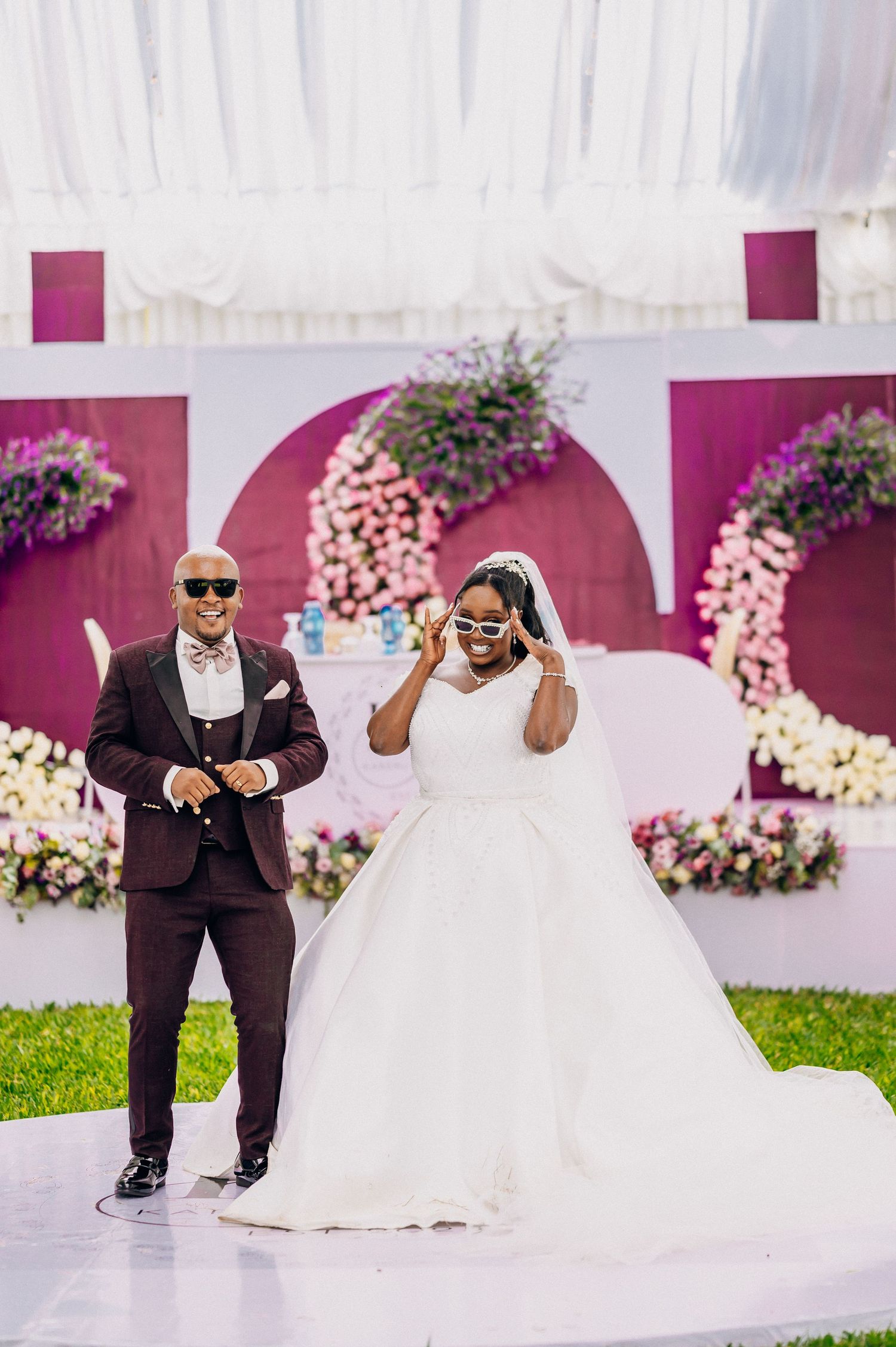 Playful wedding photo sequence against pink floral wall backdrop.