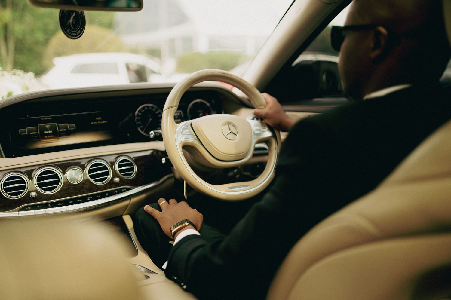Interior view of a luxury car dashboard with modern controls and displays.