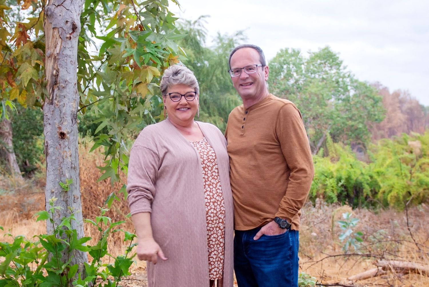 Autumn outdoor portrait series featuring couples against natural scenery.