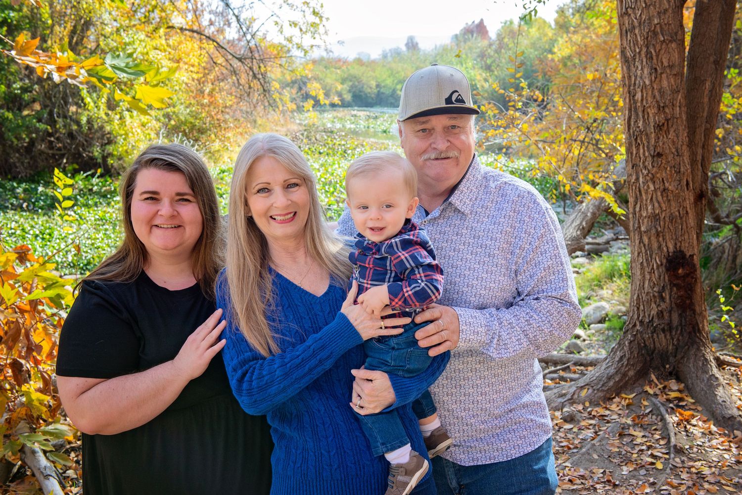 Family group photos taken in natural outdoor setting with autumn foliage.