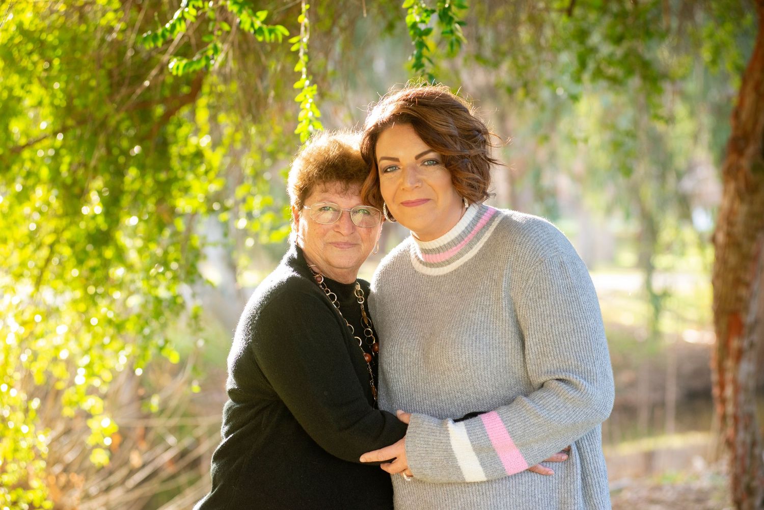 Tender outdoor portrait sequence with autumn foliage in golden sunlight. Mother and daughter.