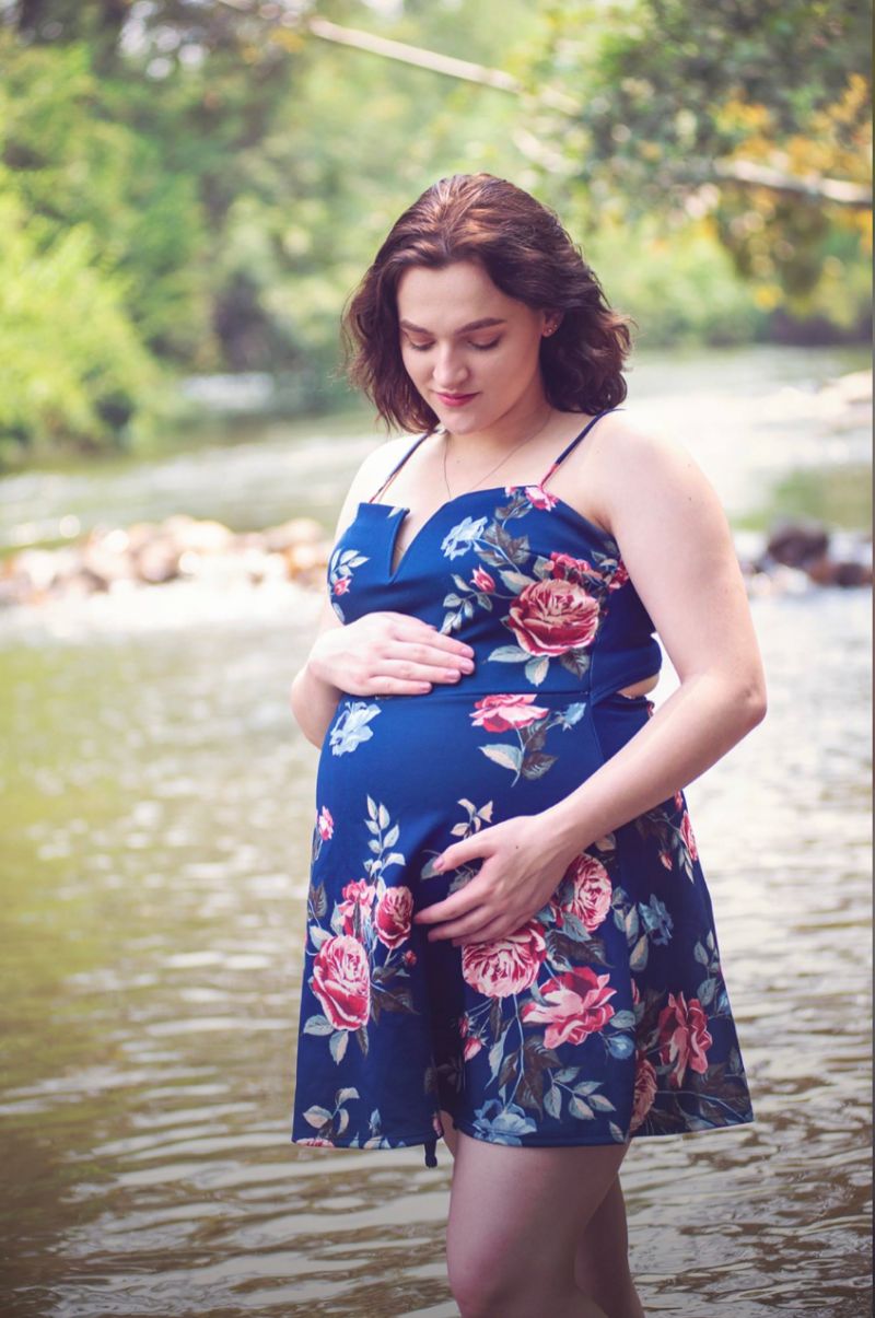 A blue floral maternity dress is showcased in a series of photos by a lake.