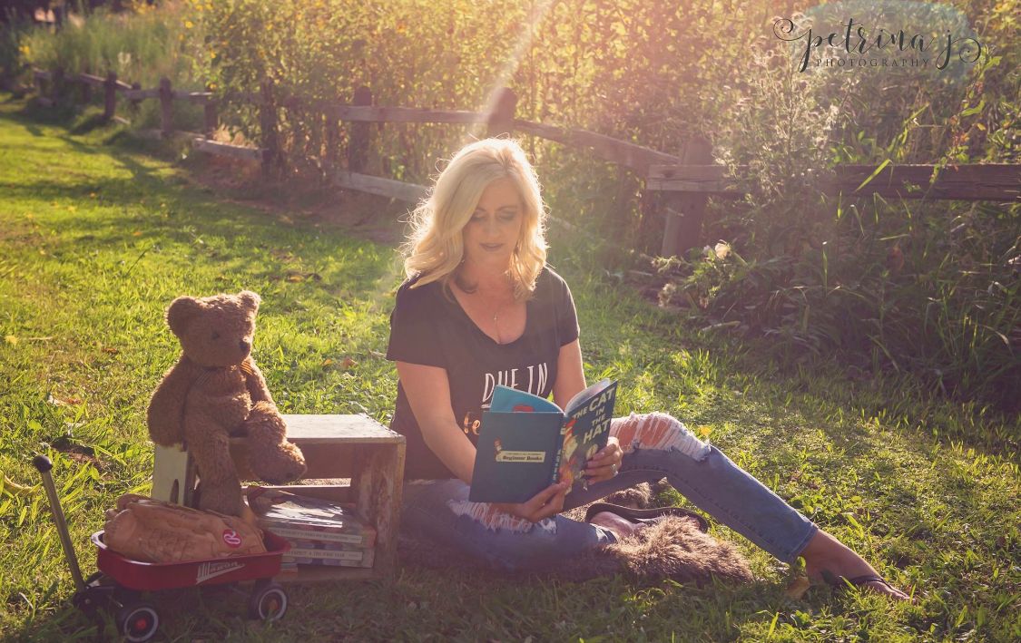 Outdoor portrait session in golden sunlit field during sunset.
