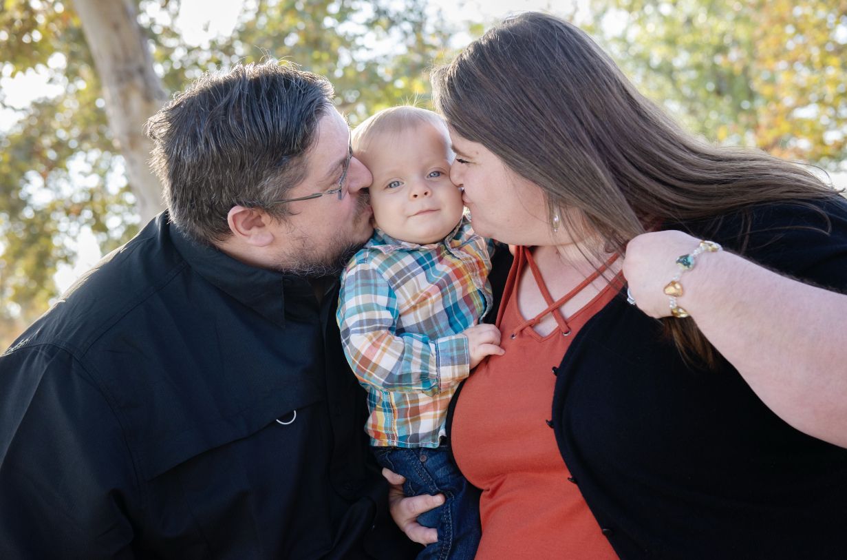 Candid family moment captured during fall outdoor photo session.