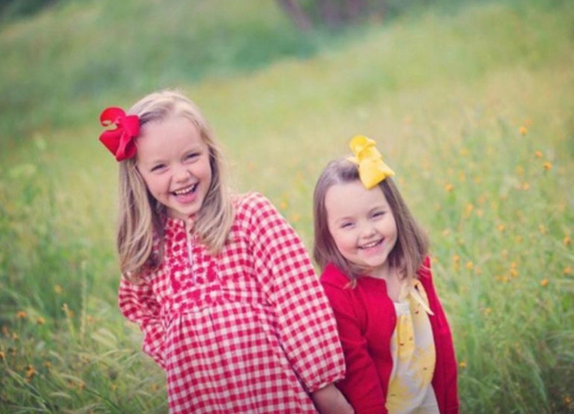 A red and white gingham dress is featured in outdoor family portraits.