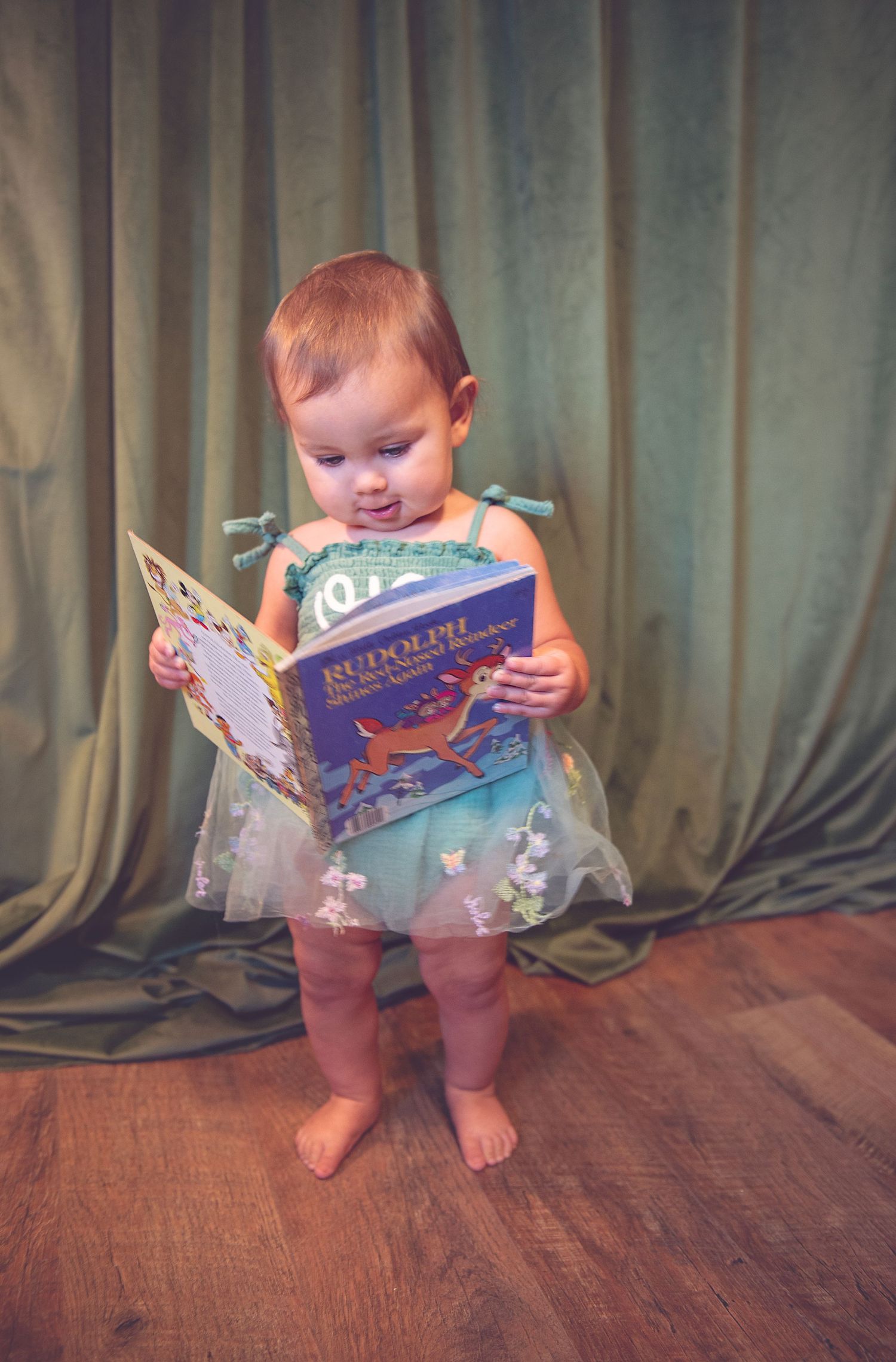A progression of images showing a small child reading a picture book while standing on hardwood floor.
