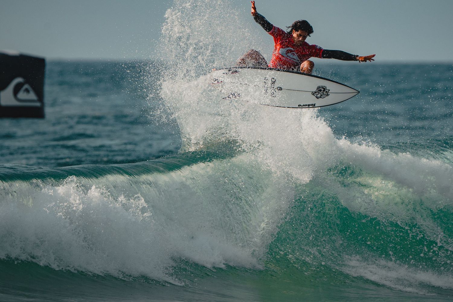 Dynamic surfing sequence showing multiple aerial tricks and wave maneuvers in turquoise waters.