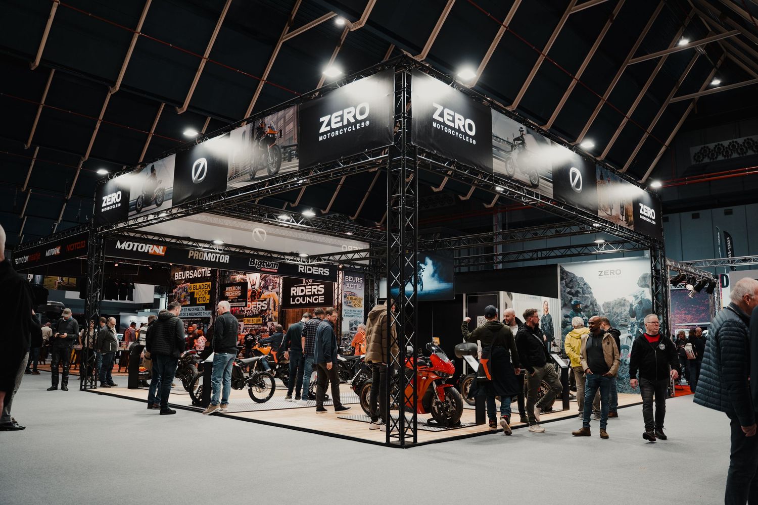 Panoramic view of a motorcycle show floor with Zero Motorcycles booth and attendees.