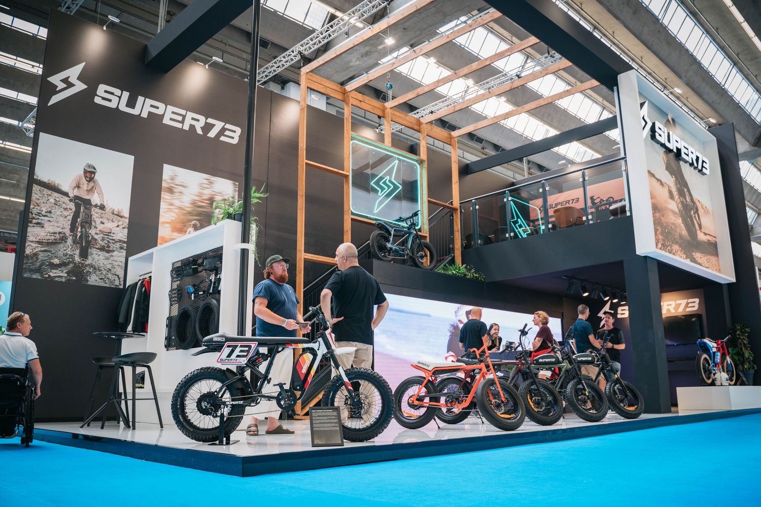 Modern motorcycle exhibition booth with bikes on display at a trade show.