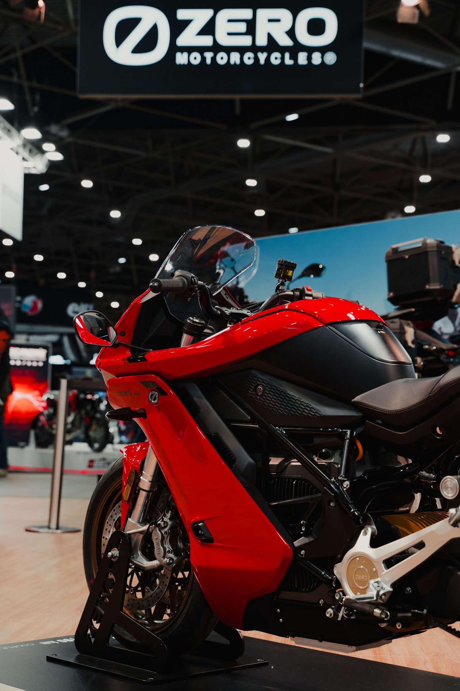 Red Zero electric motorcycles lined up on display at a motorcycle exhibition.