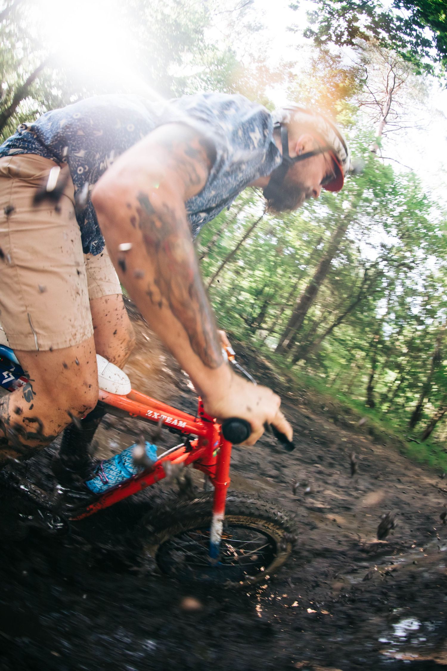 Low-angle action shots of a bike rider performing stunts on a dirt trail.