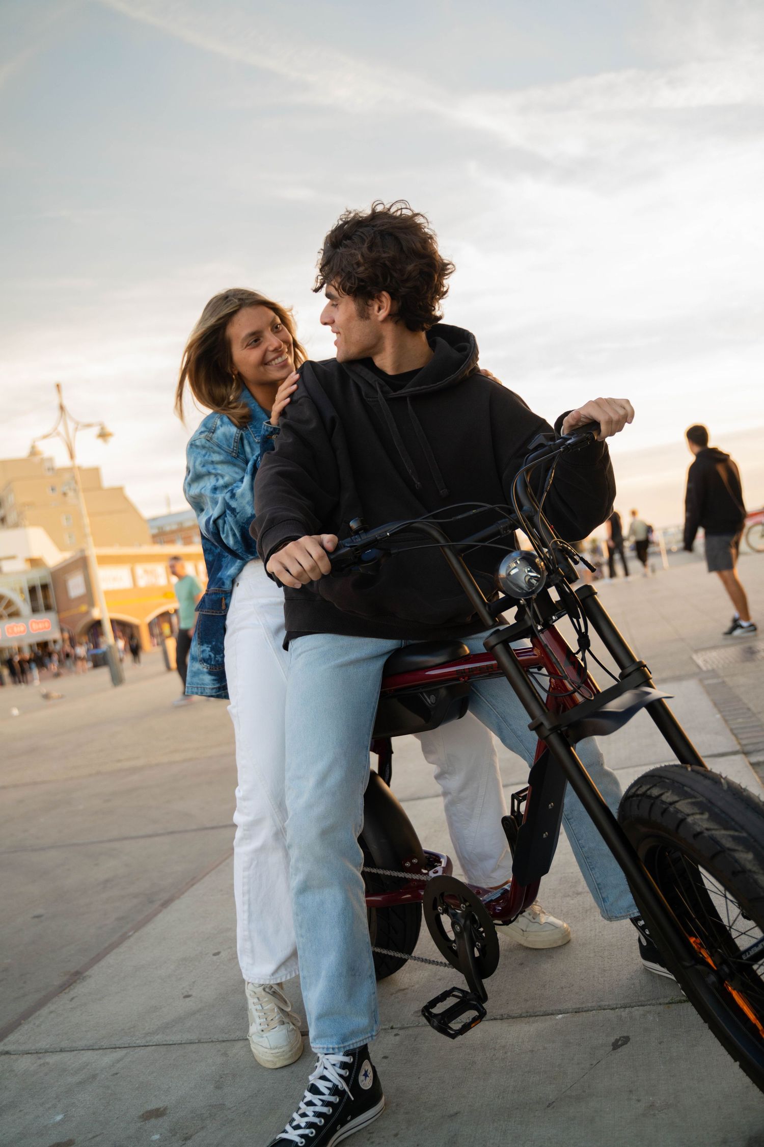 Casual hangout scene with custom bikes outside a building at sunset.