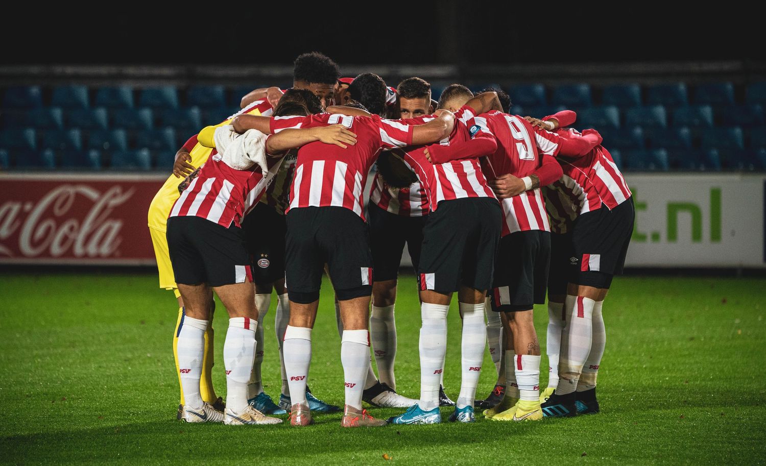 Soccer teams huddle together on the field before or after the match.