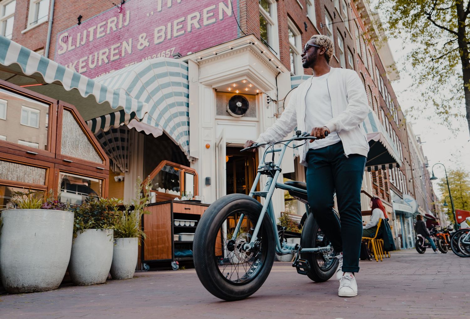 Custom bikes parked along a European street with 'Foren Bieren' signage.