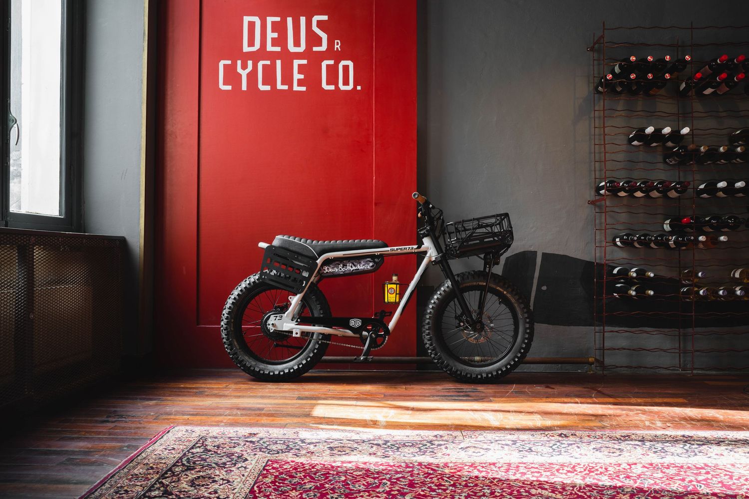 Modern motorcycle showroom interior with red walls and bikes on display.