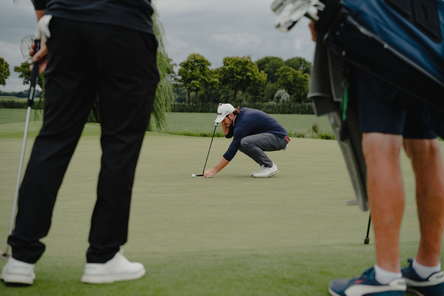 Series of golf putting stances and movements on a practice green.