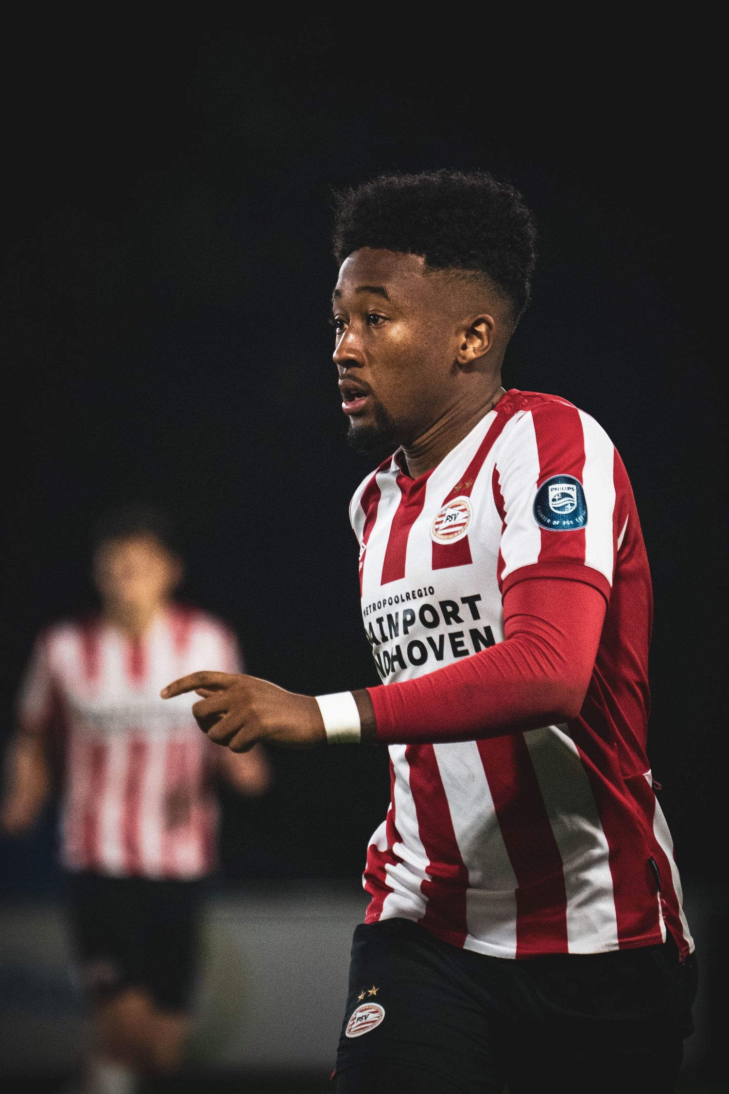 PSV Eindhoven players in their iconic red and white striped jerseys during a match.