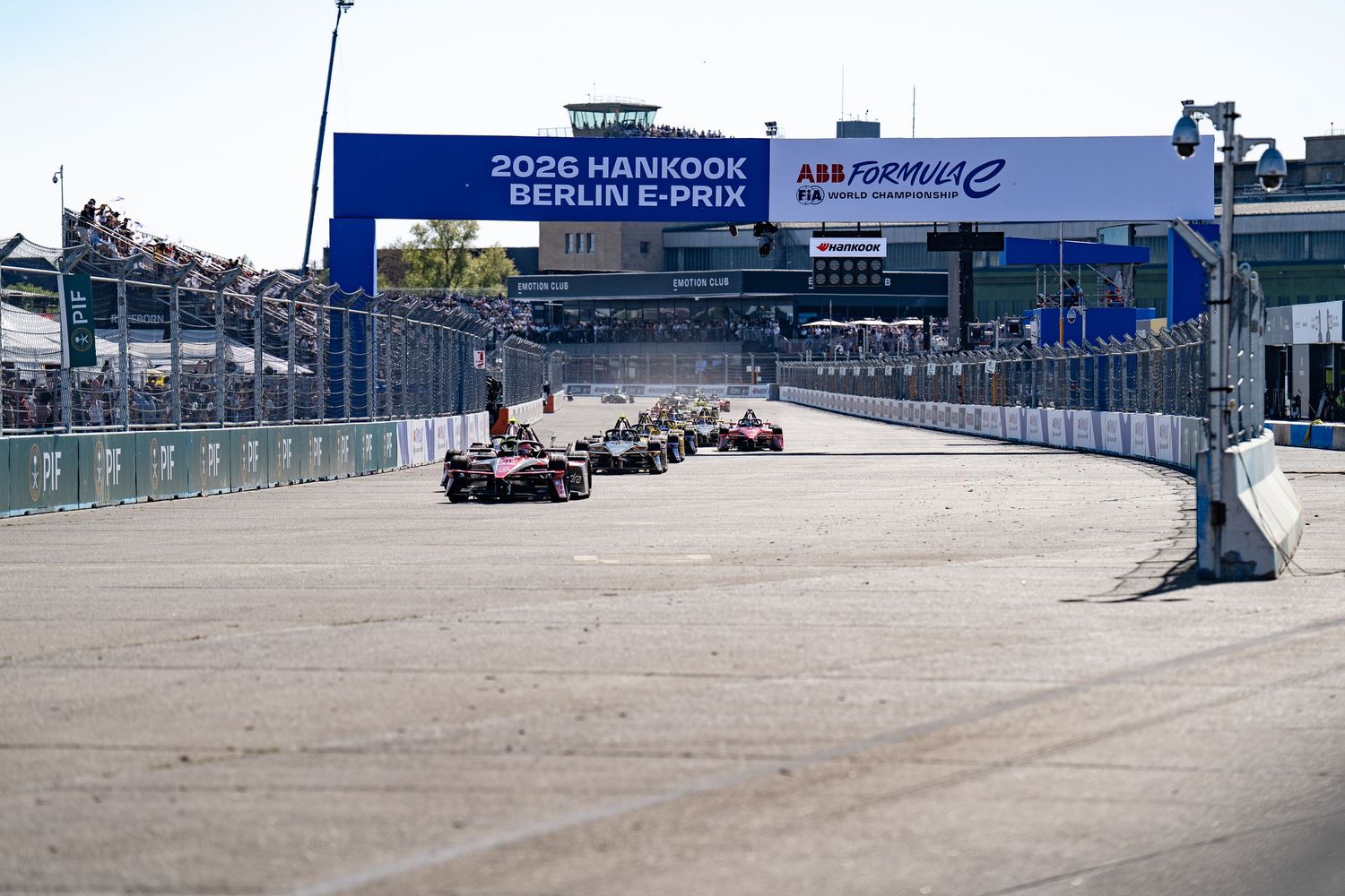 Formula E race cars competing at the 2026 Hankook Berlin E-Prix on a street circuit under sunny skies.