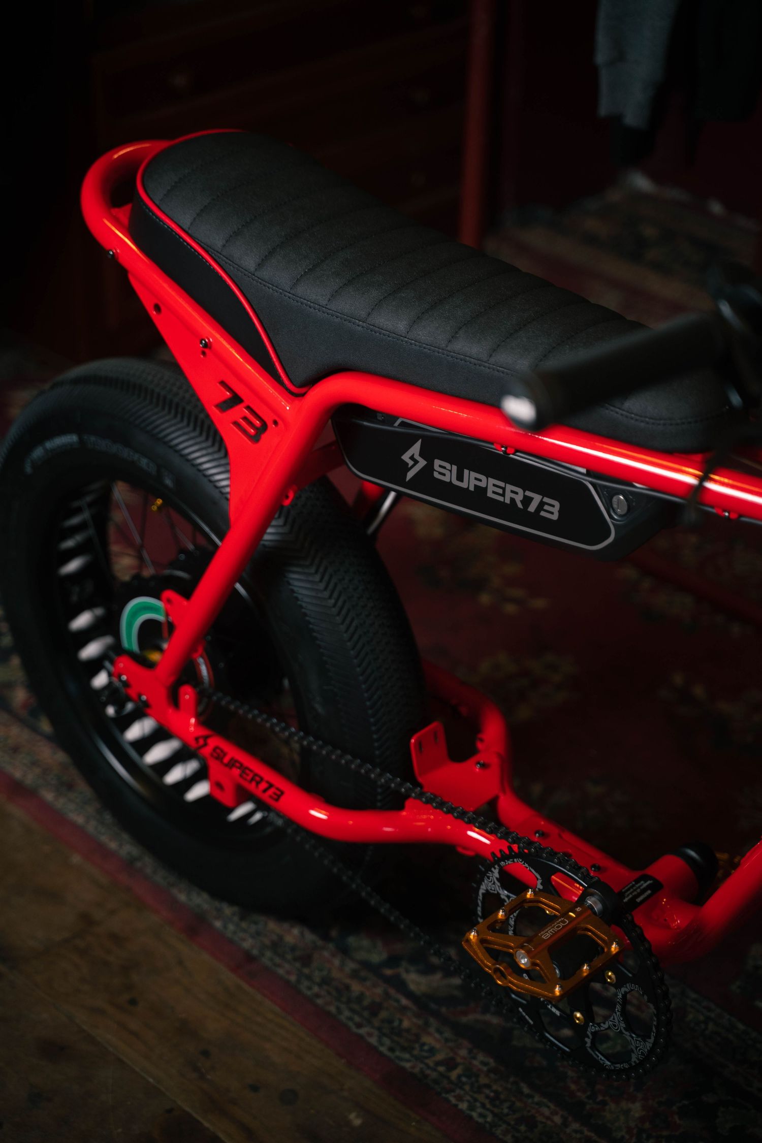 Close-up detail of red Super73 electric bike seat and frame design.