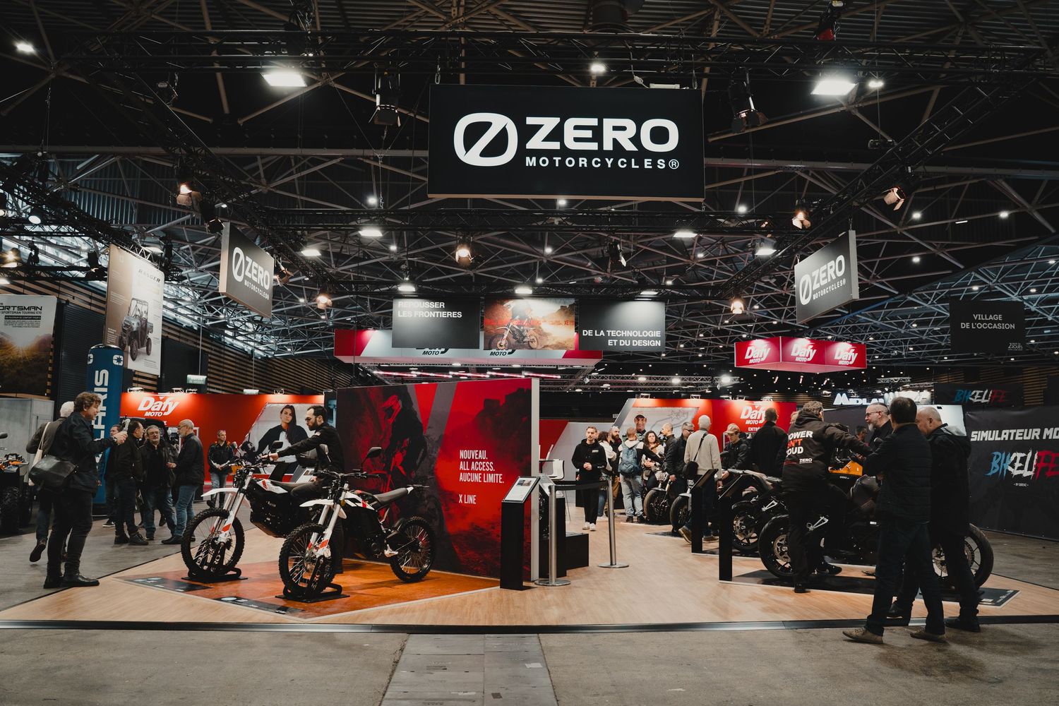 Zero Motorcycles showroom display featuring multiple electric bikes under exhibition lighting.