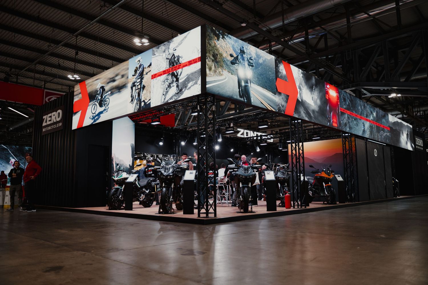 Wide view of motorcycle showroom with display bikes and promotional banners.