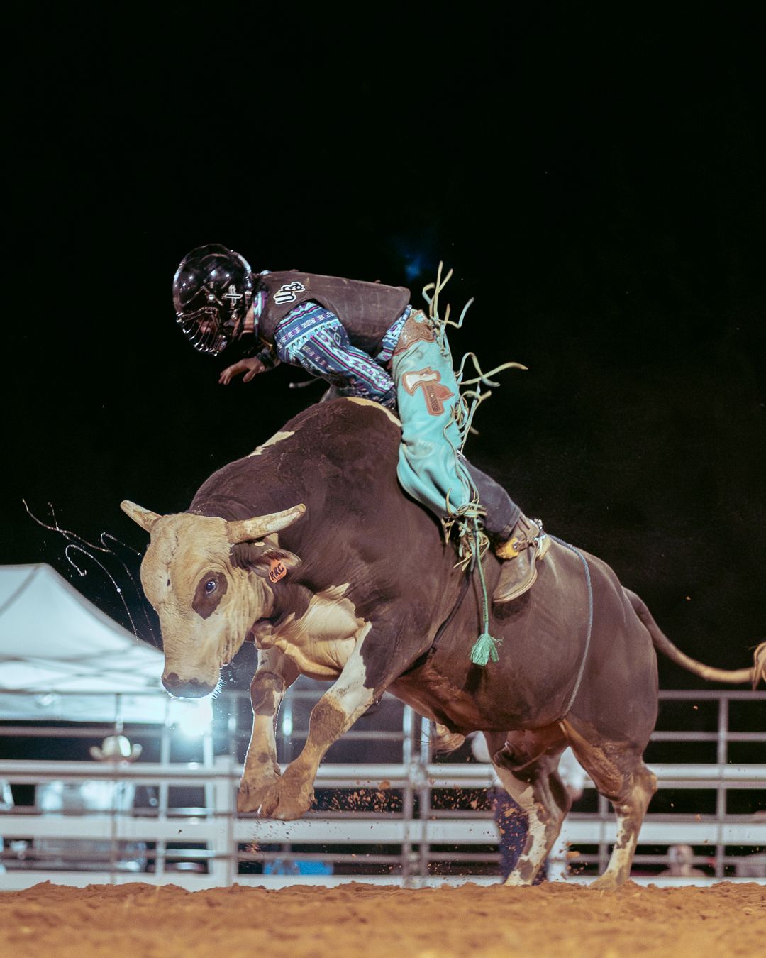 A cowboy riding a bull.
