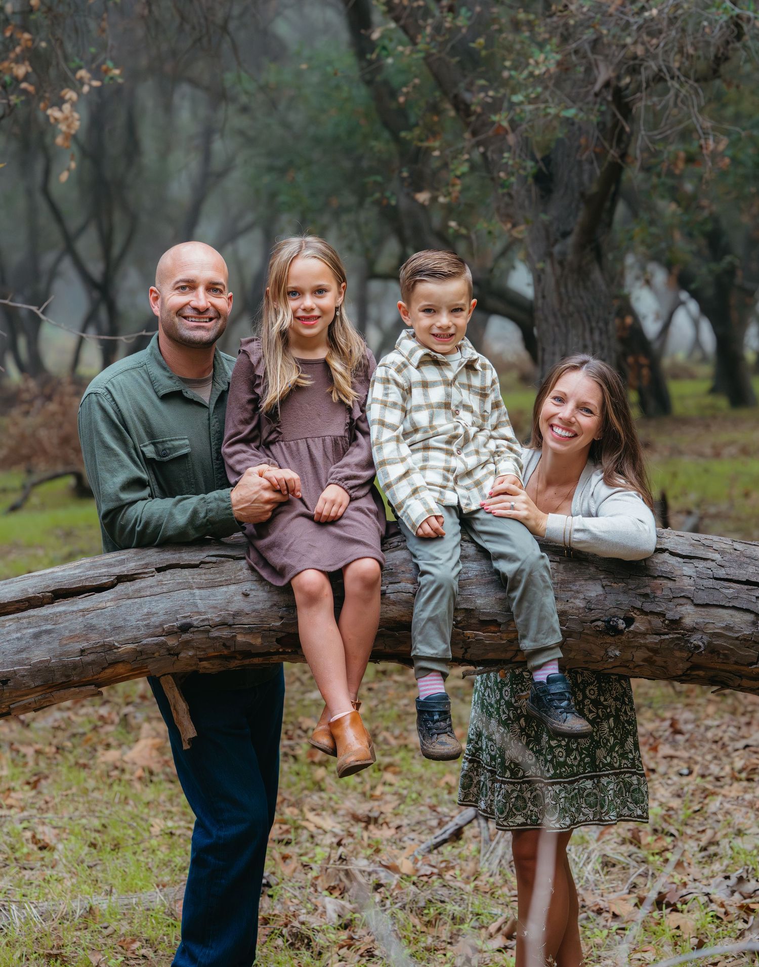 Warm golden hour environmental portrait of a family with children playing in a sunlit field in Southern California by Vince Shewmaker.