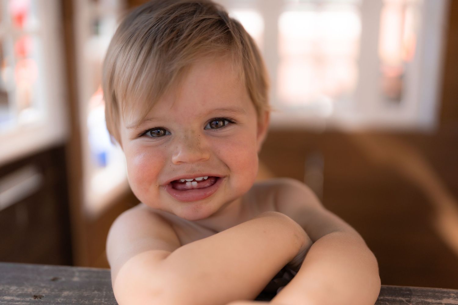 Candid environmental portrait of a young child playing in a natural outdoor setting with soft lighting by Vince Shewmaker.