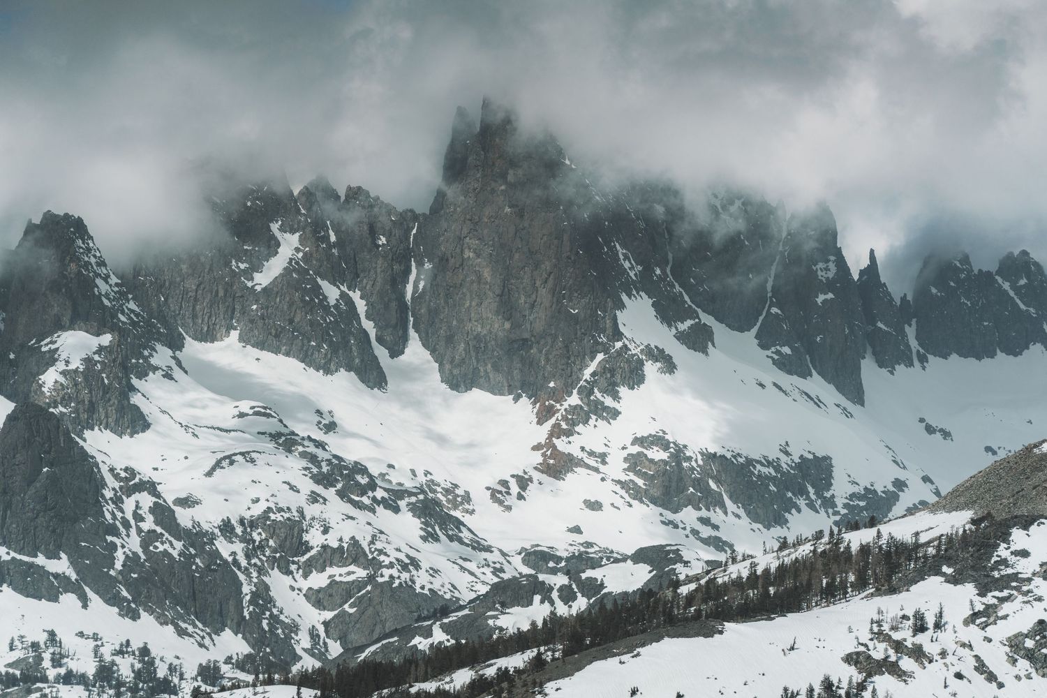 Dramatic wide-angle nature photograph of majestic mountains and under a moody sky by Vince Shewmaker.