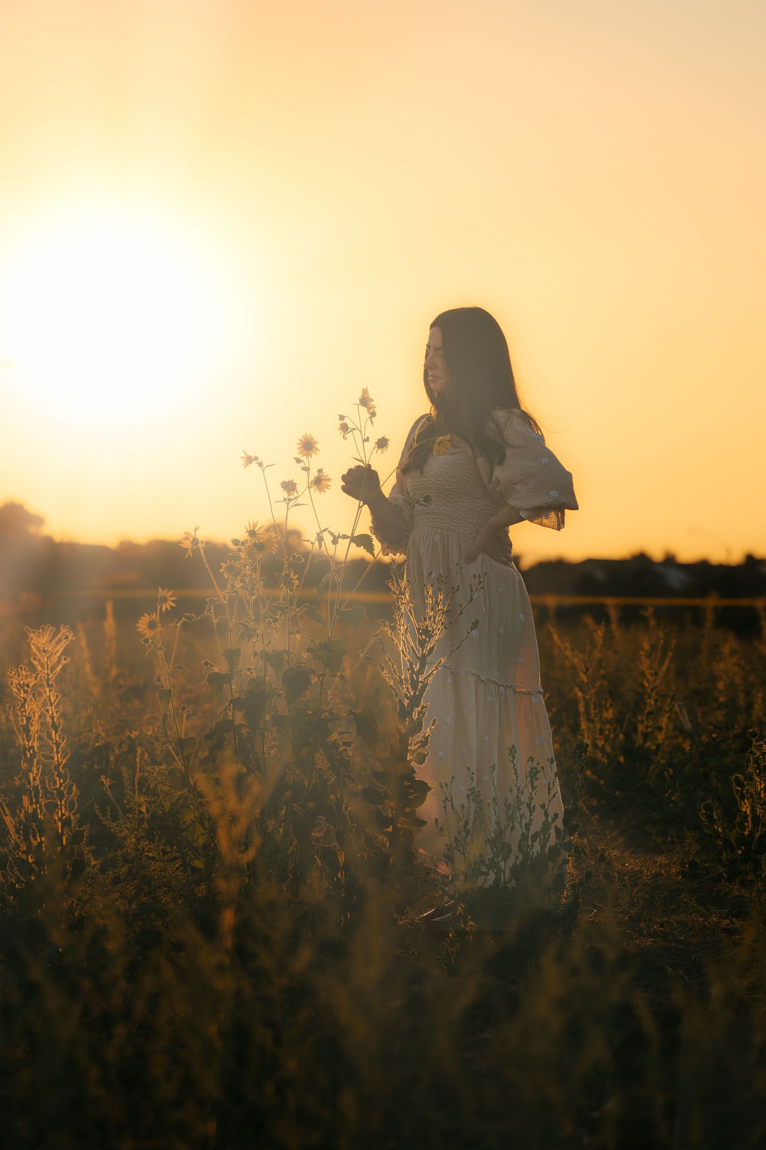 Warm golden hour environmental portrait of a woman  in a sunlit field in Southern California by Vince Shewmaker.