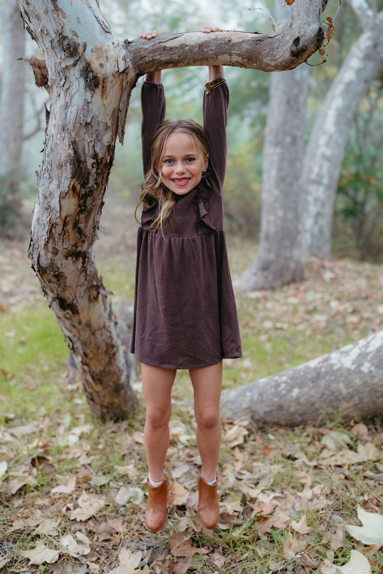 A series of photos showing a brown dress against a backdrop of eucalyptus trees and fallen autumn leaves.