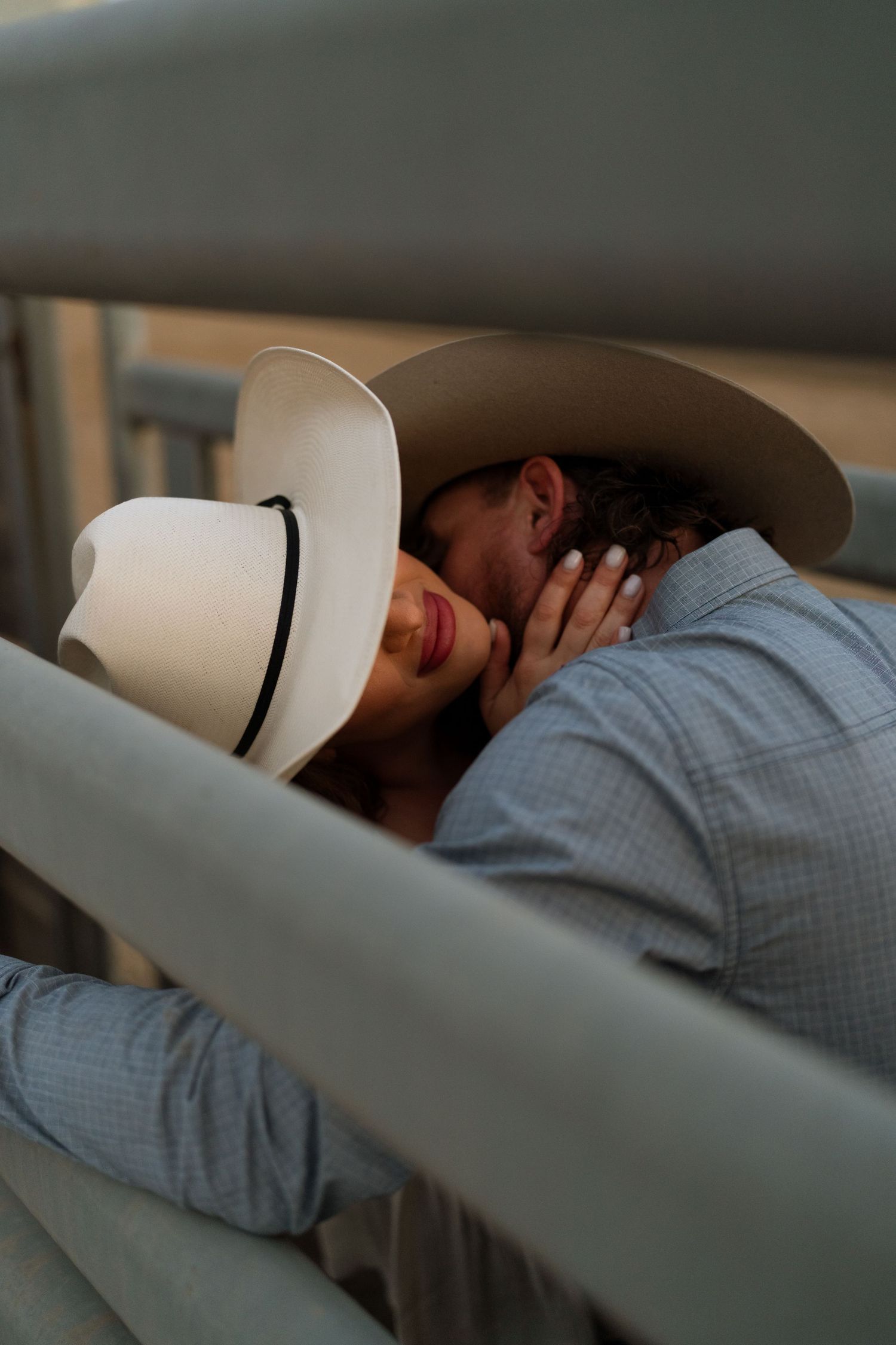 Warm cinematic portrait of a couple embracing in tall grass rolling hills at sunset in the country by Vince Shewmaker.