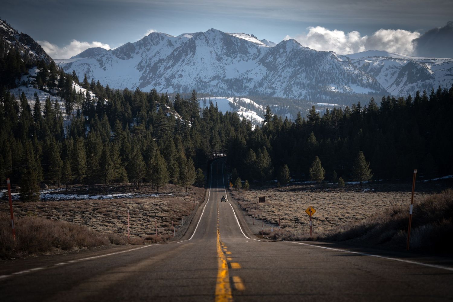 Dramatic wide-angle nature photograph of majestic mountains and under a moody sky by Vince Shewmaker.