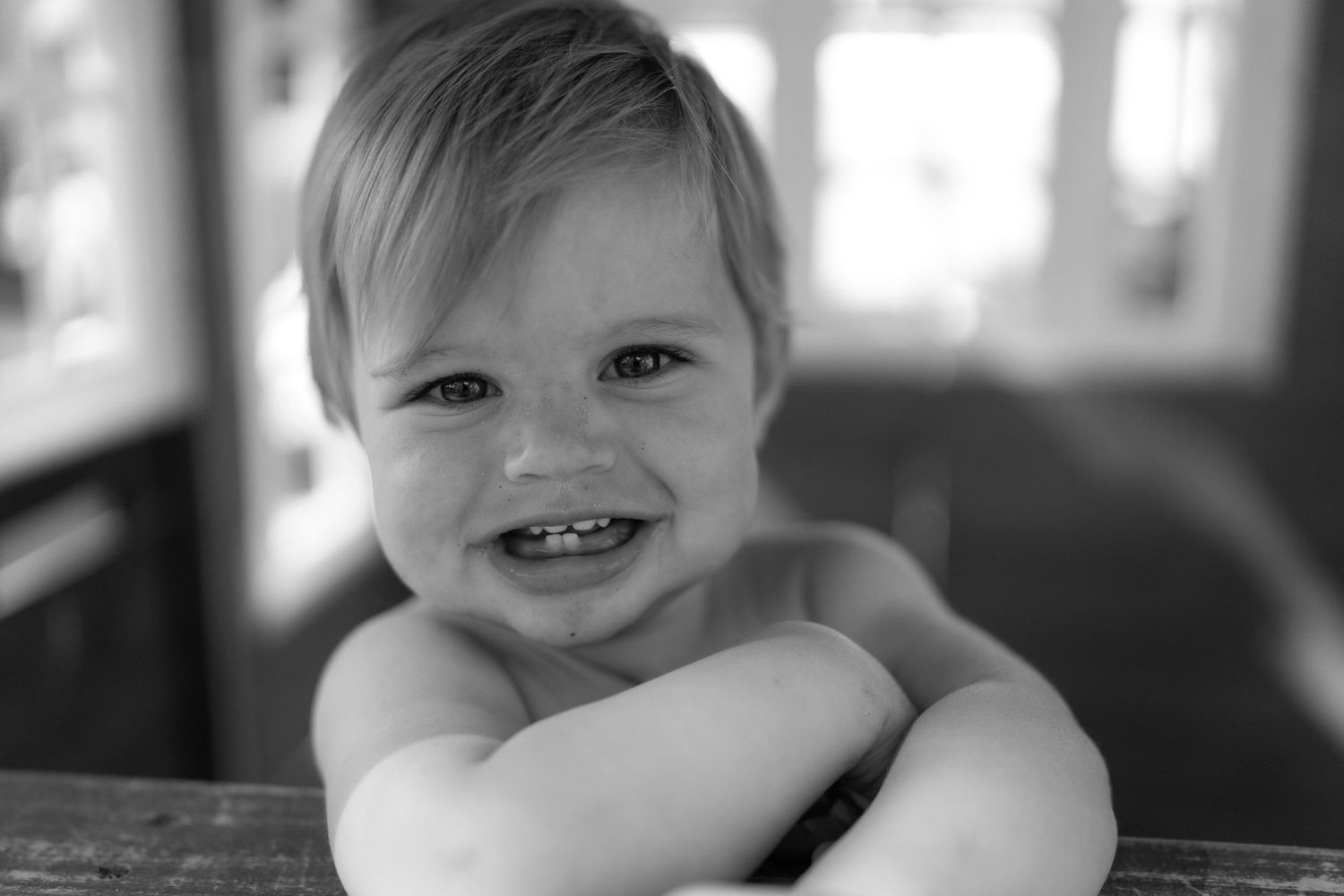 Candid environmental portrait of a young child playing in a natural outdoor setting with soft lighting by Vince Shewmaker.